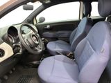 the interior of a small car with blue seats and a steering wheel