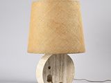 a close up of a lamp on a table with a lamp shade on it