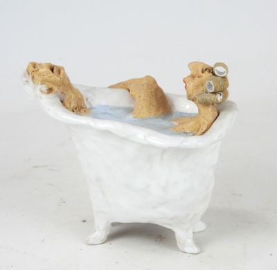 figurine of a teddy bear in a bathtub with a teddy bear