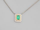 an emerald and diamond pendant on a chain
