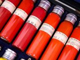 many bottles of different colors of paint in a case