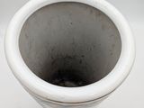 a white vase that is sitting on a table