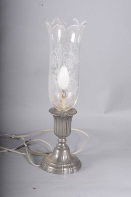 a lamp that is sitting on a table next to a cord