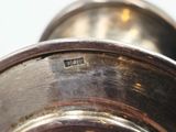 a close up view of a silver plate with a metal handle