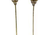 a pair of emerald and diamond hair pins