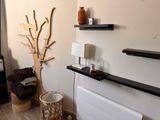 a picture of a living room with a radiator and a tree
