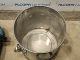 a large metal pot with a handle on the floor