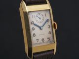 an image of a gold wrist watch with a brown leather strap