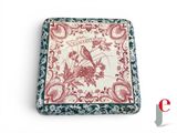 a red and white box with a bird design on it