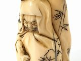 a figurine of a woman holding a cat