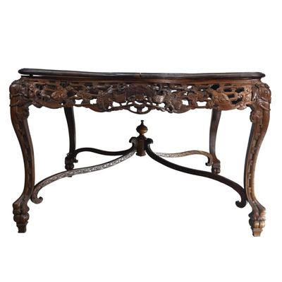 an ornately carved console table with a marble top