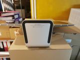 a white and black air purifier sitting on top of a cardboard box