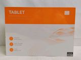 an orange and white box of a tablet sitting on a table