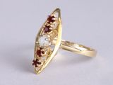 an image of a gold ring with garnets and pearls