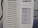 an image of a white air conditioner sitting on top of a counter