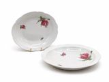 a white plate with a pink flower on it and a white plate with a pink flower on it