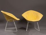 a pair of yellow chairs sitting next to each other on a gray surface