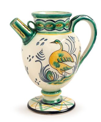 a green and white vase with a bird on it