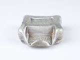 a silver plate with a small bowl inside of it