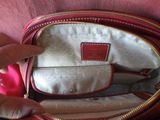 someone is holding a red purse with a red handle and a red handle