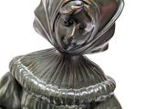 a statue of a woman with a hat on her head
