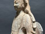 an old statue of a woman holding a baby in her arms