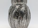 a silver vase that is sitting on a table