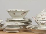 a lot of white dishes and cups on a table