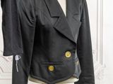 black jacket on a mannequin stand with a black shirt on a mannequin stand