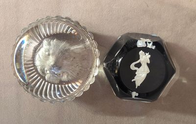 a glass ashtray and a glass ashtray on a table