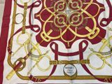 a red and white scarf with gold designs on it