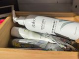 a bottle of lotion sitting inside of a wooden box