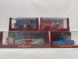 three toy vehicles are in a display case on a white surface