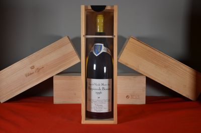 a bottle of wine in a wooden box on a table