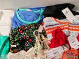 a lot of clothes that are sitting on a table