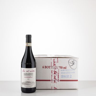 bottle of red wine next to a box of wine on a table