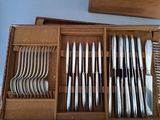 a lot of silverware in a box on the table