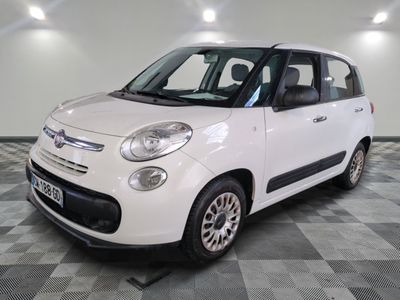 the small white car is parked on a checkered tile floor