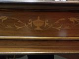 a close up of a wooden table with a bird design on it