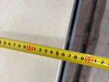 a measuring tape that is being used to measure a piece of wood
