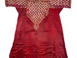 a red silk tunic with a gold and red design on the chest