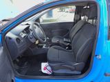 the interior of a small blue car with black leather seats