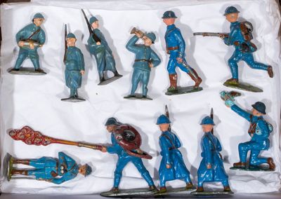 many figurines of men in blue uniforms in a box