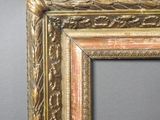 an antique gold frame with a decorative pattern on the edges