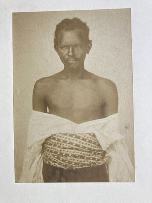 an old photo of a man with a basket on his chest