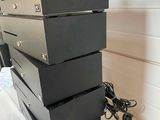 a stack of four black boxes on a white table