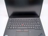 the laptop is open on a white surface with a black keyboard