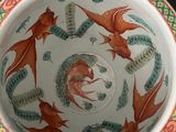 a bowl with a design of fish and plants on it