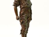 une statue antique en bronze représentant un garçon coiffé d'un chapeau