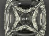 square clear glass ashtray on a black background